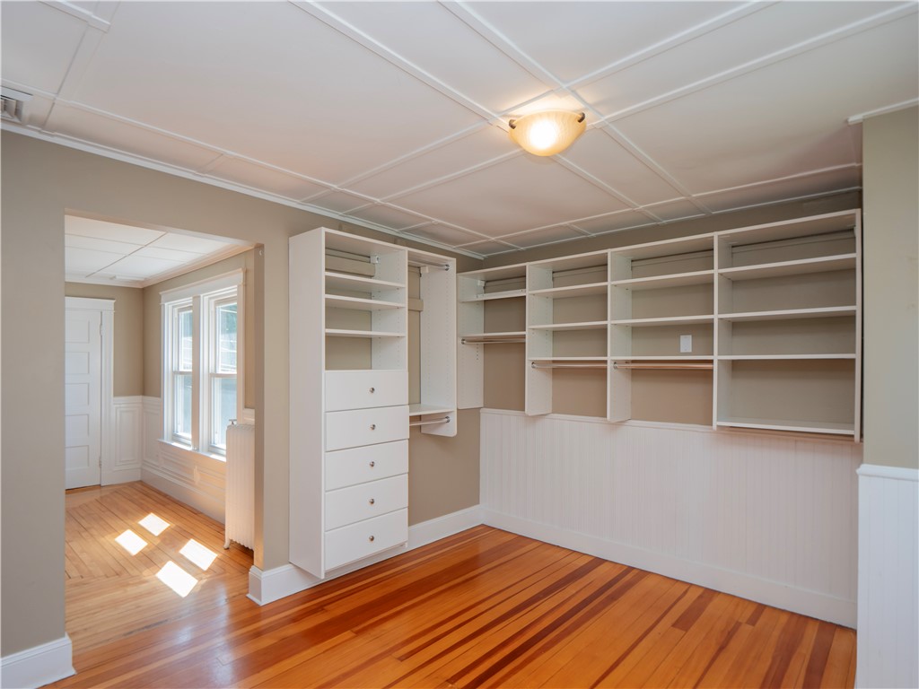 573 Spring Street Newport, RI 02840 - Photo 33 of 50 Primary Suite walk in closet dressing area with ensuite bath view to bedroom