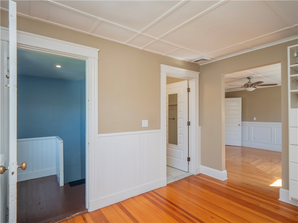 573 Spring Street Newport, RI 02840 - Photo 34 of 50 Primary Suite walk in closet dressing area with ensuite bath, back stairway view to bedroom