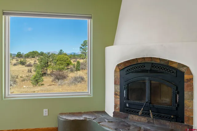 a living room with a fireplace and a window