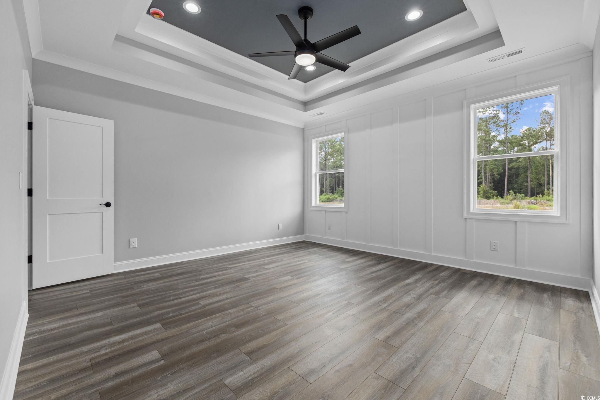 6922 Pauley Swamp Road Conway, SC 29527 - Photo 17 of 40 Unfurnished room with dark wood-style floors, recessed lighting, a raised ceiling, ceiling fan, and ornamental molding