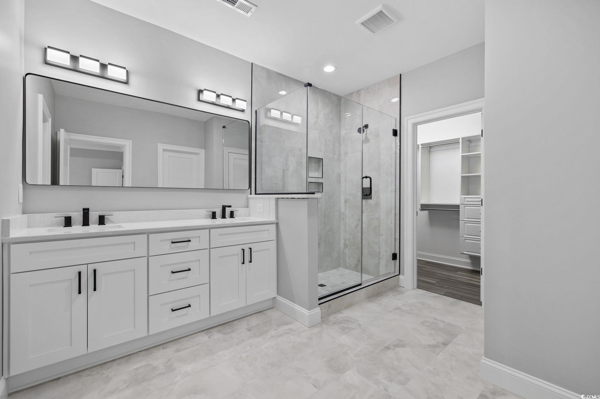 6922 Pauley Swamp Road Conway, SC 29527 - Photo 18 of 40 Bathroom with a spacious closet, a shower stall, double vanity, and recessed lighting