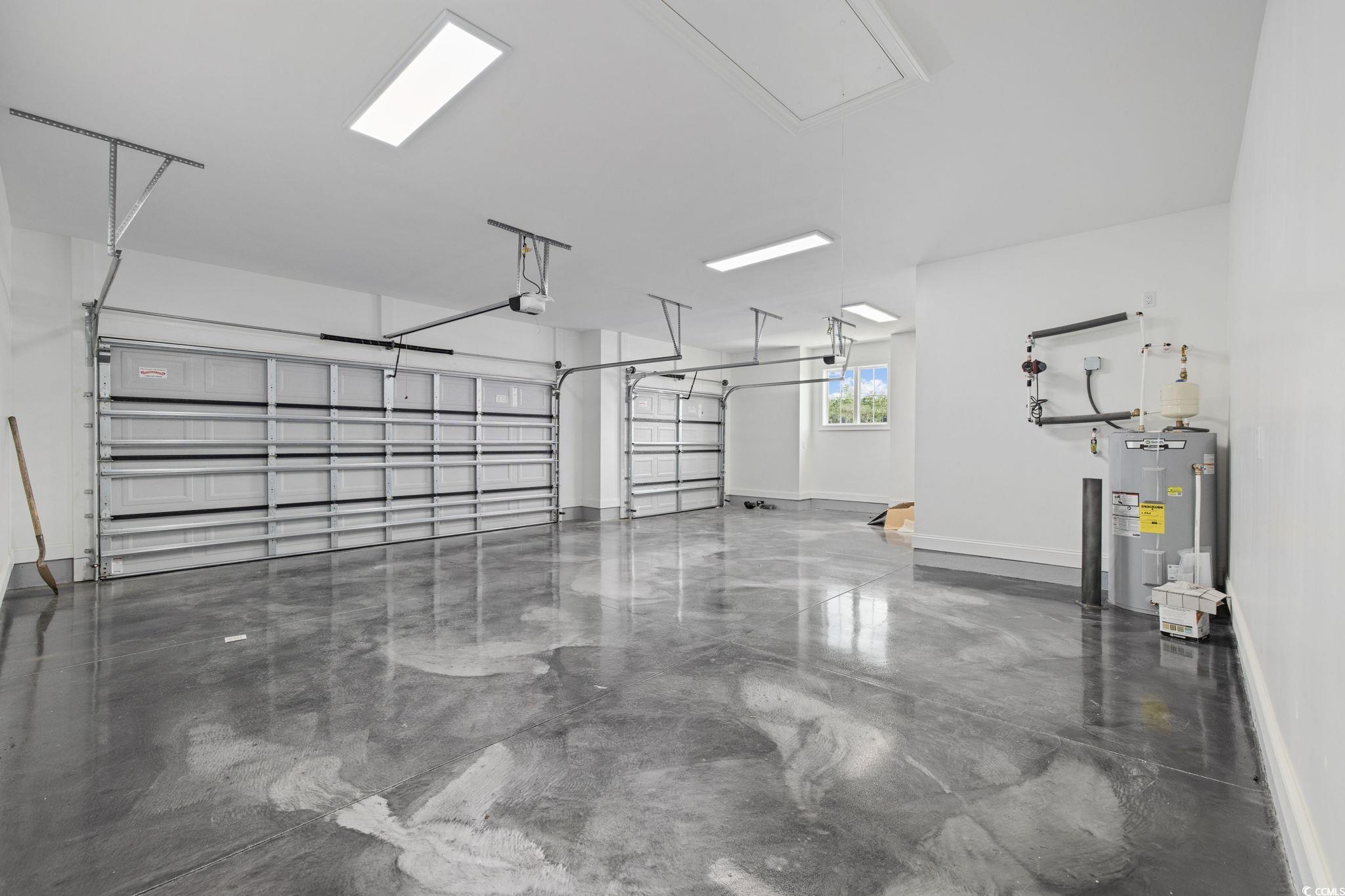 6922 Pauley Swamp Road Conway, SC 29527 - Photo 24 of 40 Garage featuring water heater and baseboards