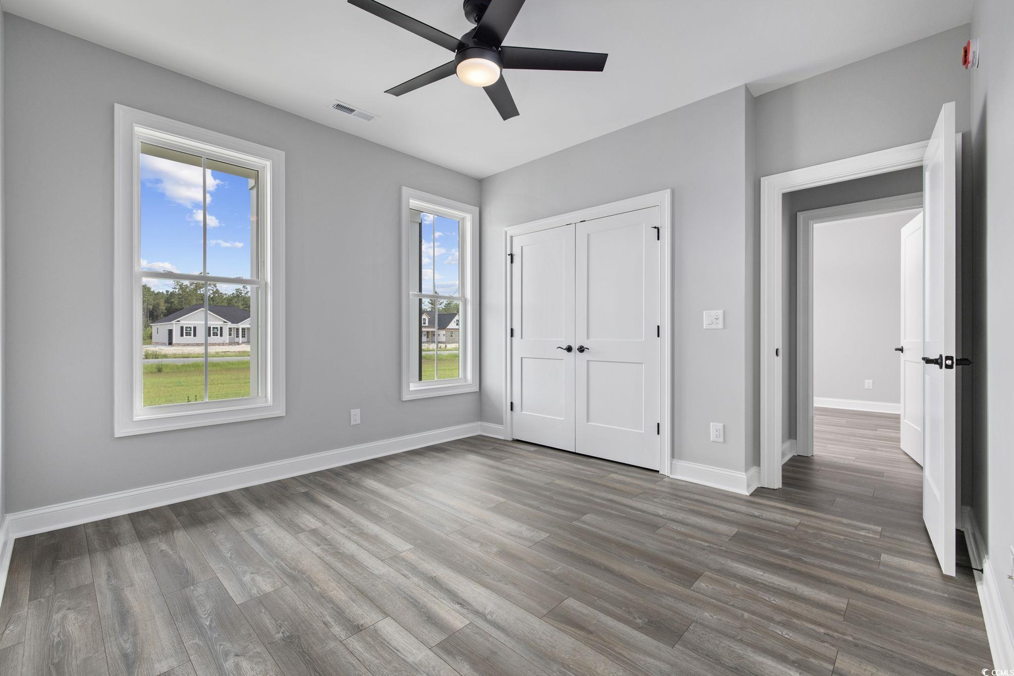 6922 Pauley Swamp Road Conway, SC 29527 - Photo 25 of 40 Unfurnished bedroom with wood finished floors, a ceiling fan, and a closet