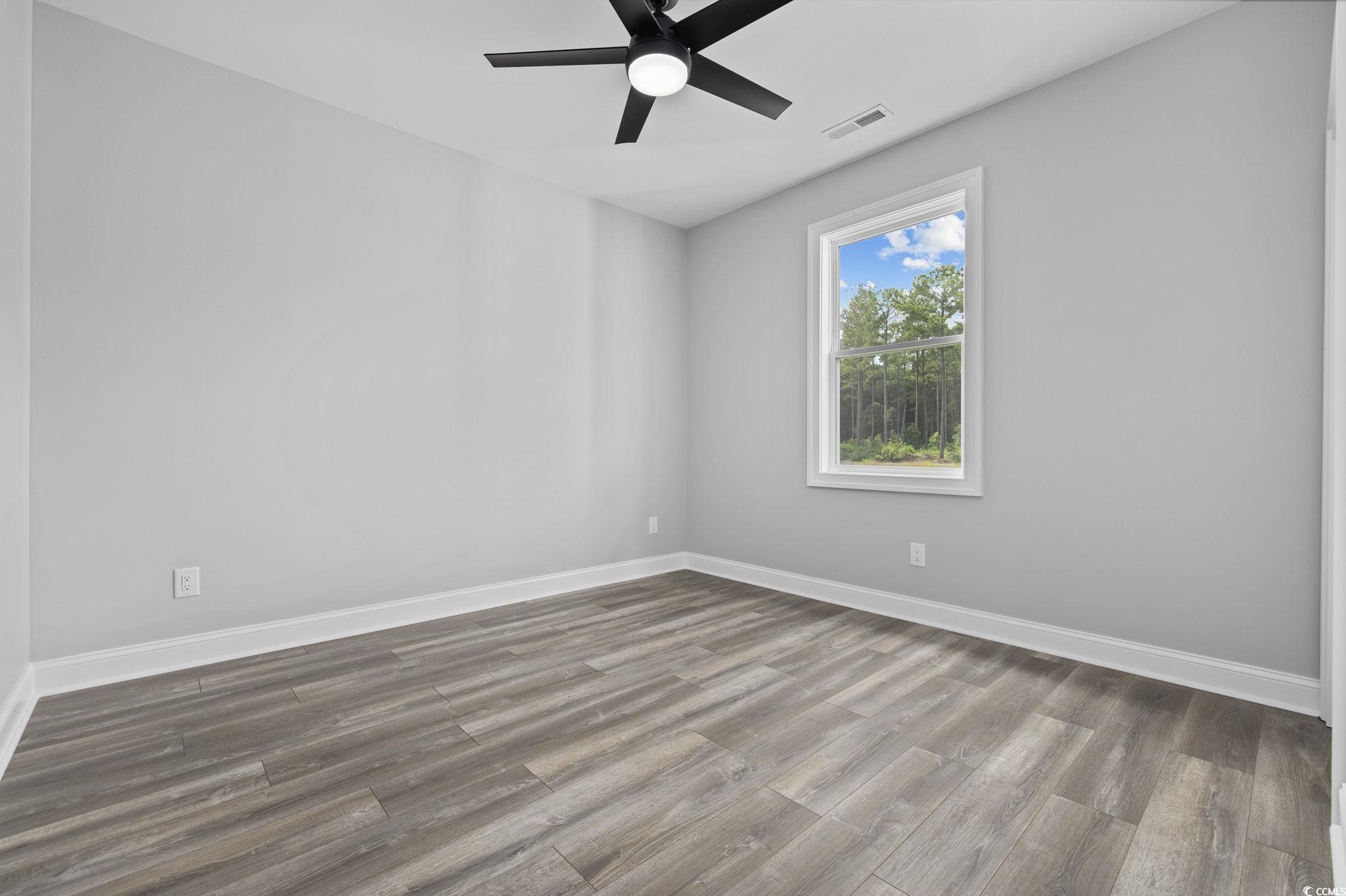 6922 Pauley Swamp Road Conway, SC 29527 - Photo 27 of 40 Spare room with wood finished floors and ceiling fan
