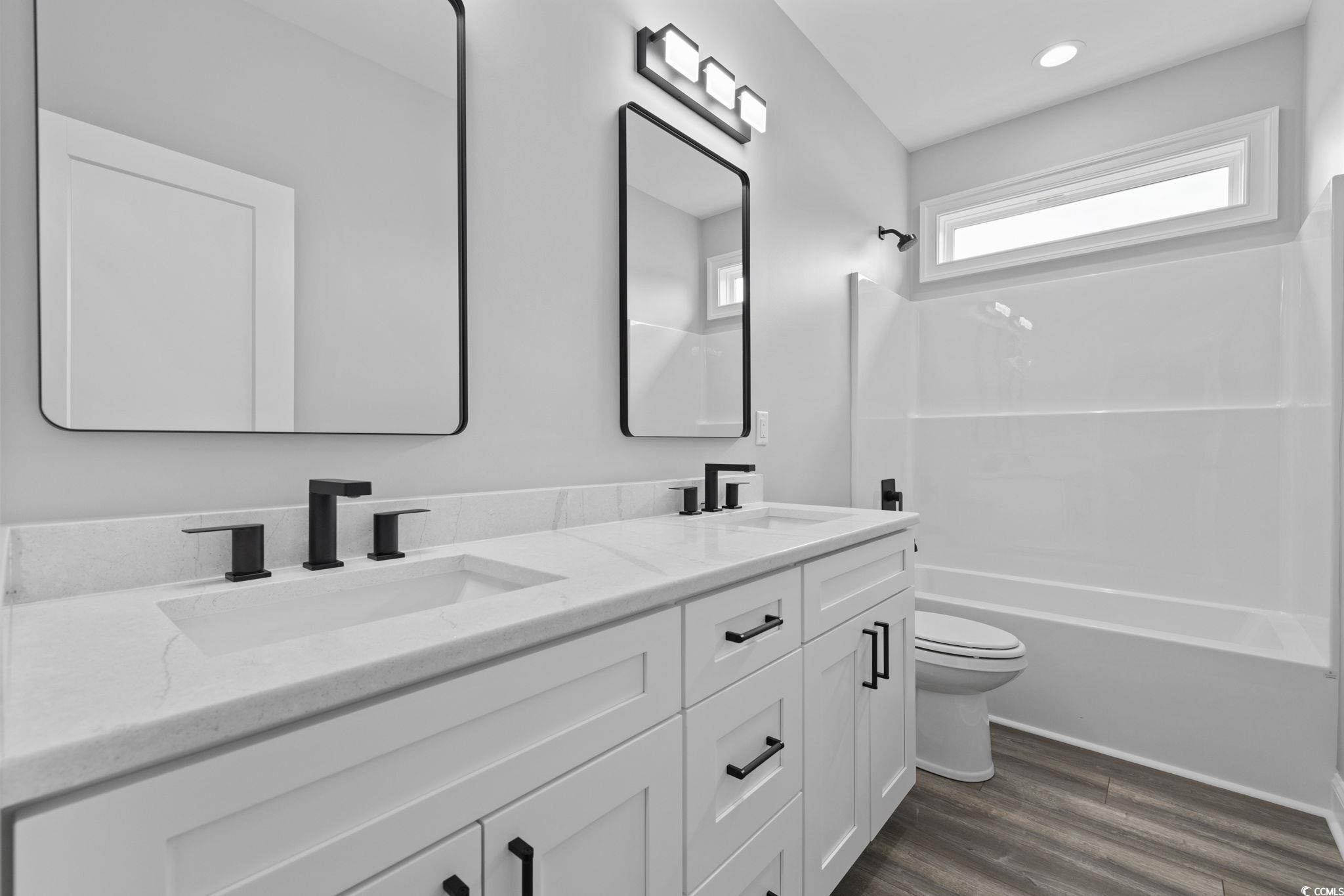 6922 Pauley Swamp Road Conway, SC 29527 - Photo 29 of 40 Full bath with bathtub / shower combination, dark wood finished floors, and double vanity