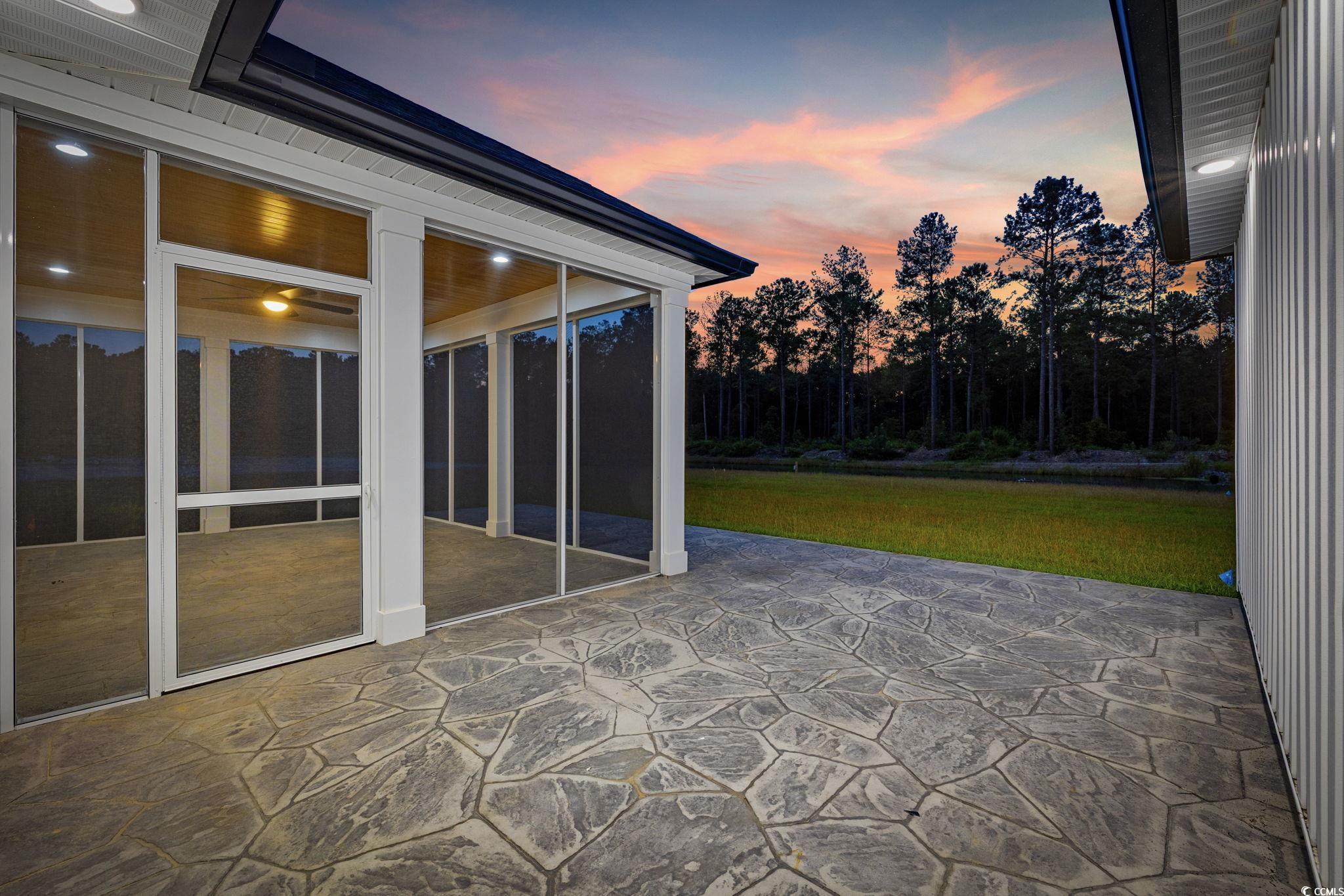 6922 Pauley Swamp Road Conway, SC 29527 - Photo 33 of 40 Patio terrace at dusk featuring a yard and a sunroom