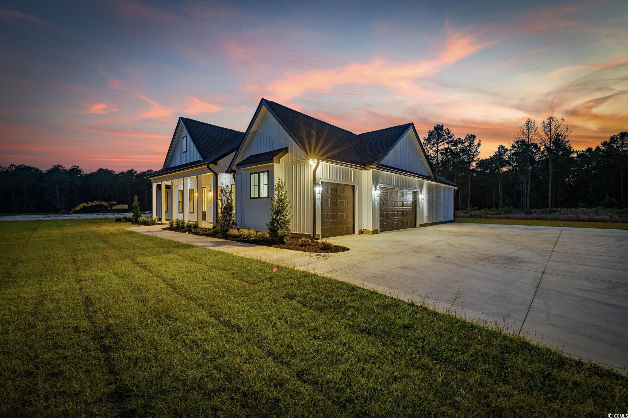 6922 Pauley Swamp Road Conway, SC 29527 - Photo 4 of 40 Modern farmhouse style home with a garage, a porch, driveway, and a lawn