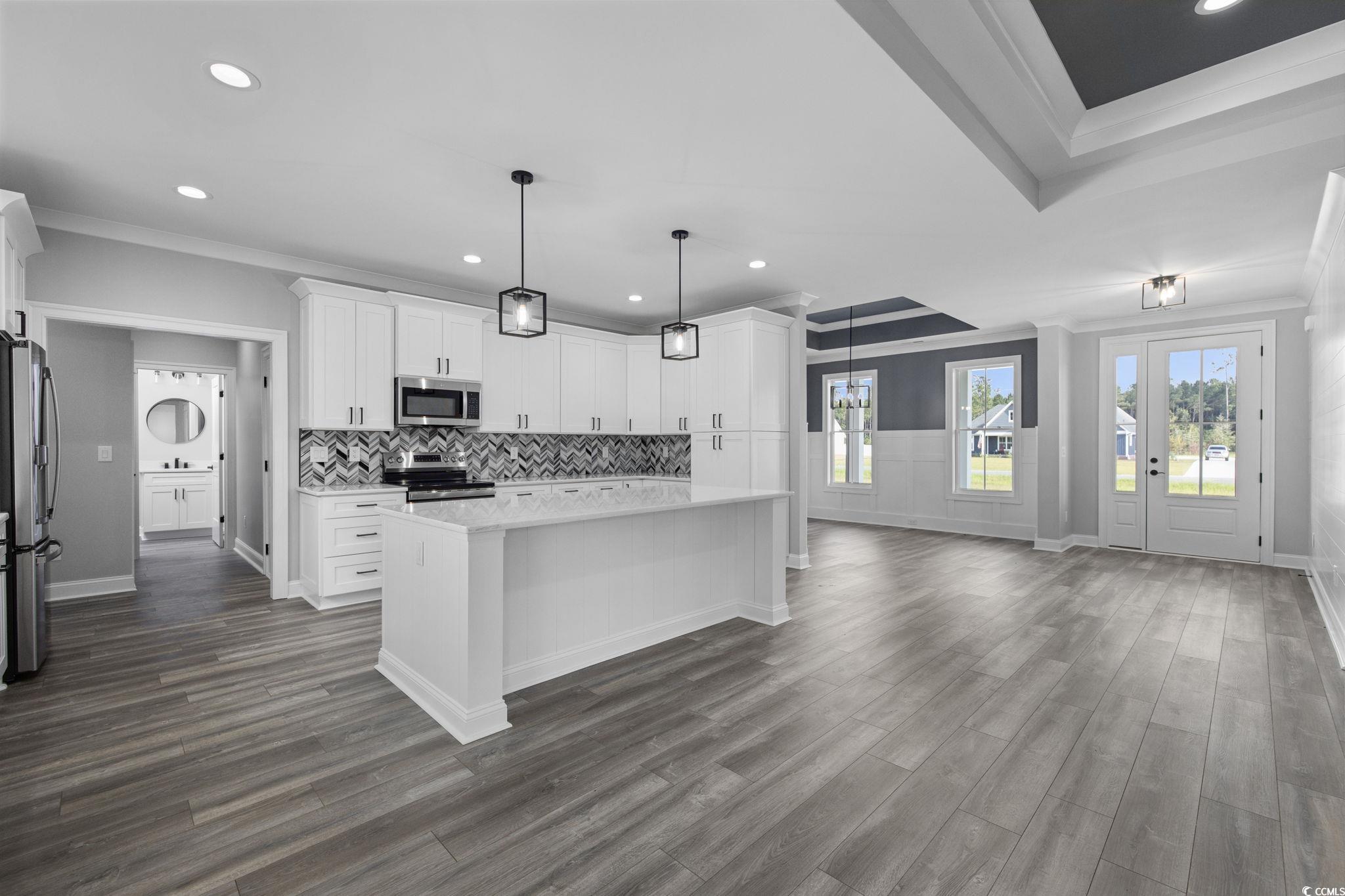 6922 Pauley Swamp Road Conway, SC 29527 - Photo 8 of 40 Kitchen with crown molding, recessed lighting, white cabinets, pendant lighting, and tasteful backsplash