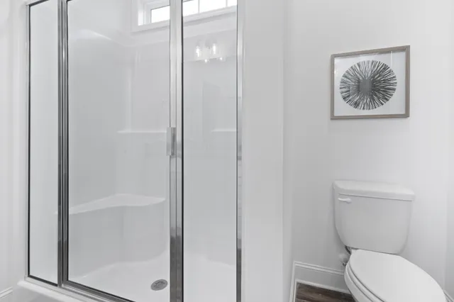 a white toilet sitting next to a bathroom sink