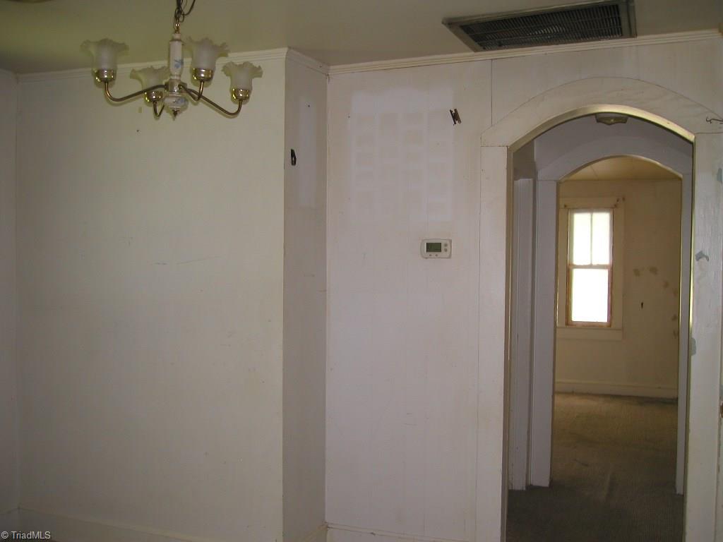 781 Cornatzer Road Mocksville, NC 27028 - Photo 7 of 14 Dining room with arched entry to bathroom on left and living room ahead.