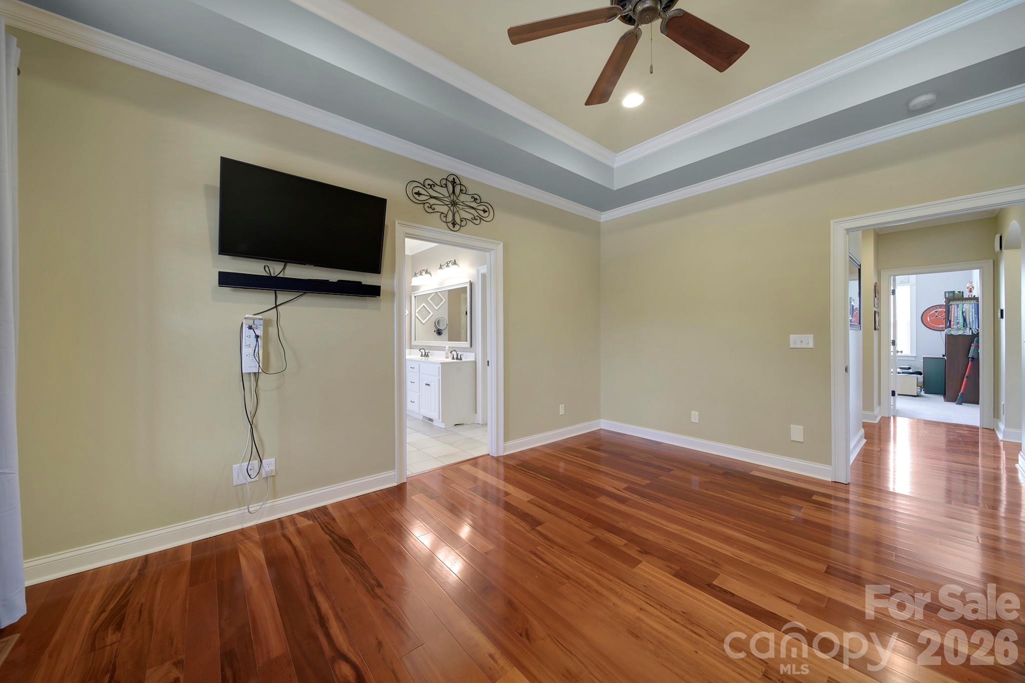 2407 Robert Usher Road Lancaster, SC 29720 - Photo 21 of 47 a view of a livingroom with a flat screen tv wooden floor and a ceiling fan