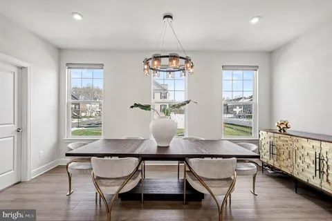 a dining room with furniture and wooden floor