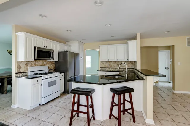 a kitchen with a sink cabinets and stainless steel appliances