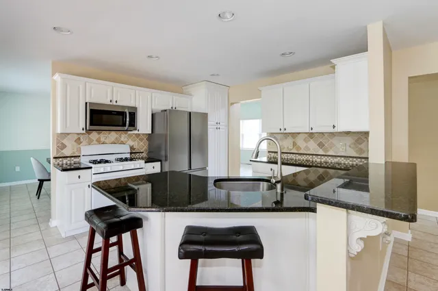 a view of a livingroom with furniture and an empty room