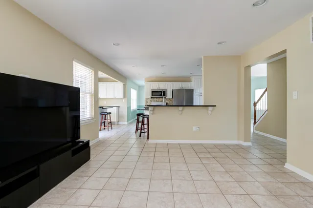 a view of a room with a window and wooden floor