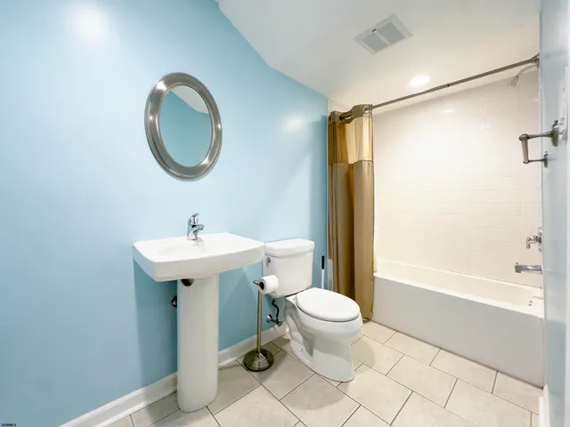 an aerial view of residential houses with outdoor space and parking