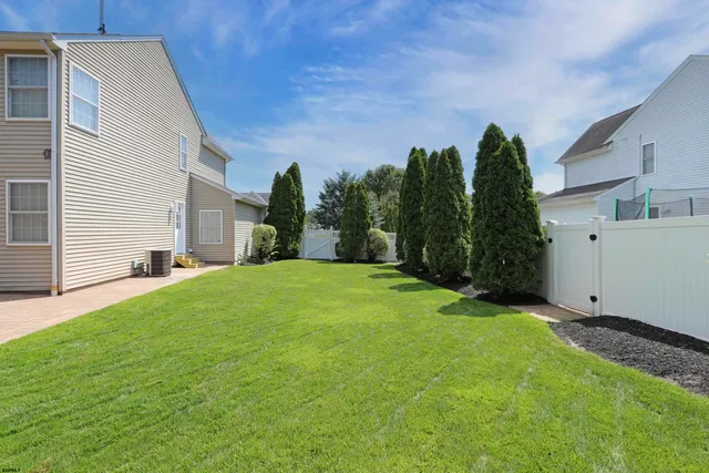 an aerial view of residential houses with outdoor space and parking