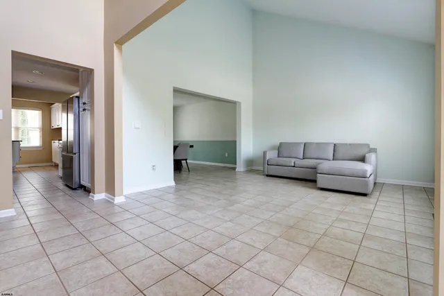 a living room with furniture and stairs