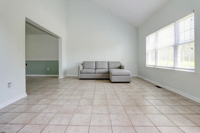 a view of a livingroom with wooden floor and furniture