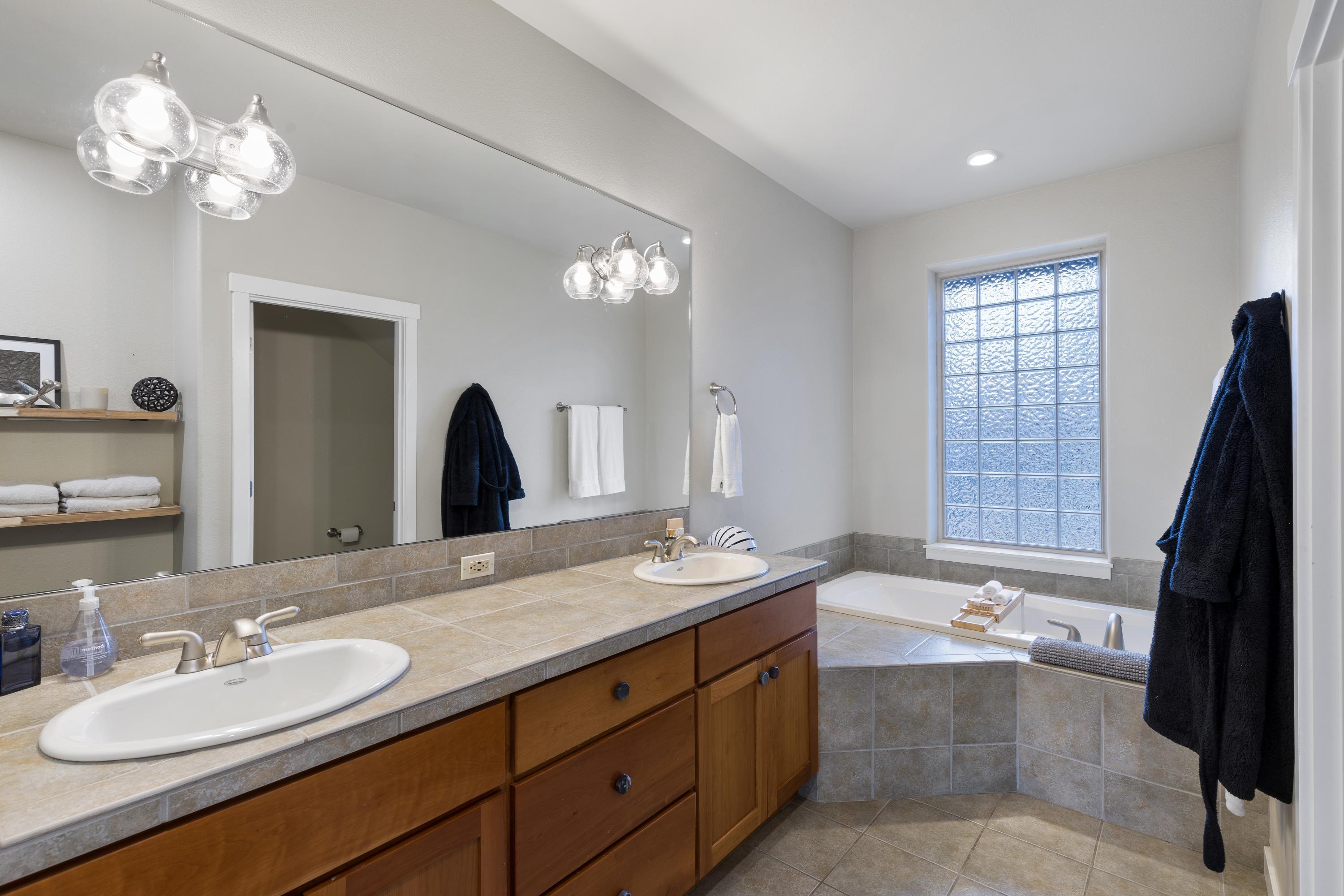 1281 Highland View Loop Redmond, OR 97756 - Photo 16 of 42 Primary bathroom, featuring a dual vanity, tub, and walk-in shower.