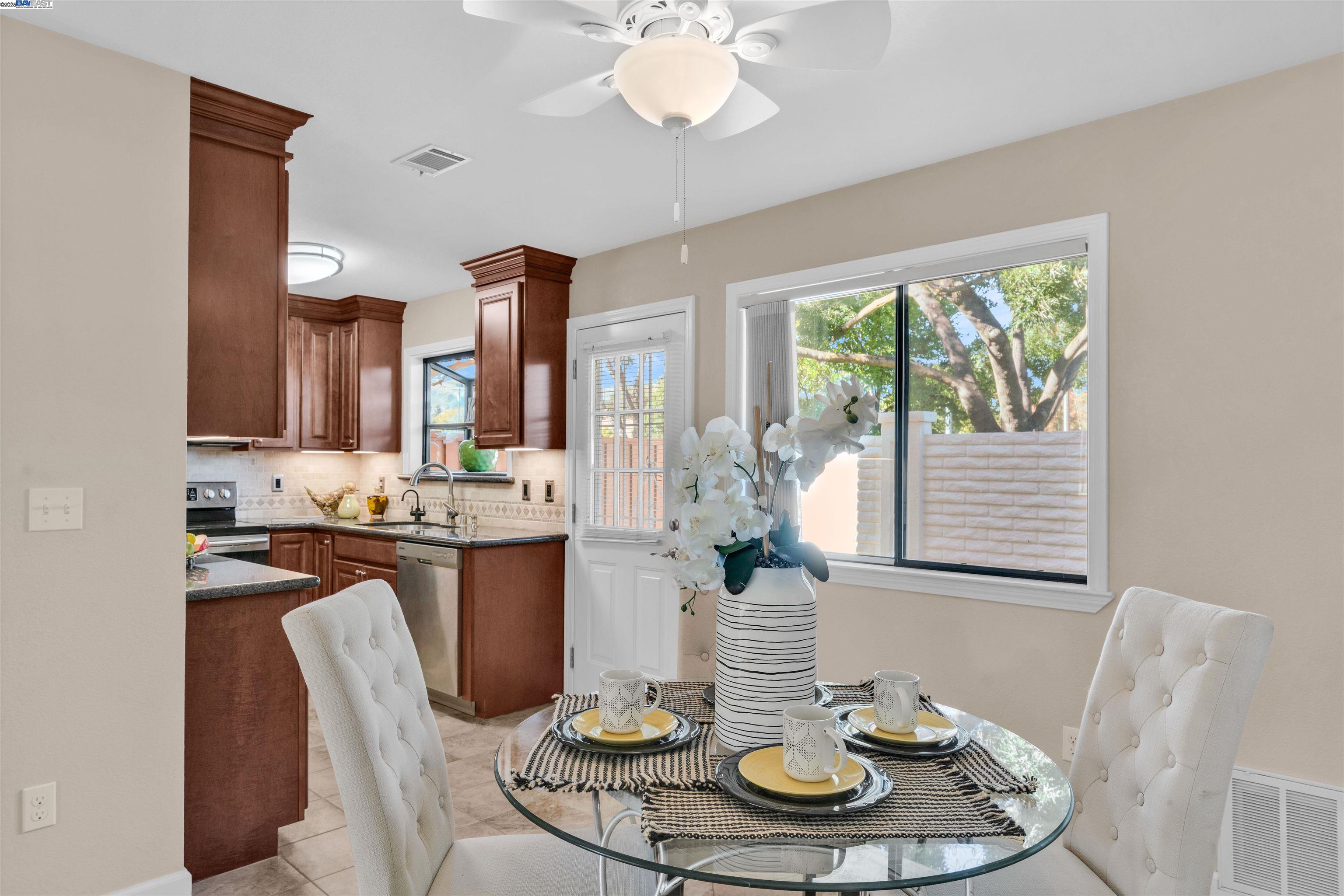 7602 Arbor Creek Circle Dublin, CA 94568 - Photo 12 of 47 a dining room with furniture and a chandelier
