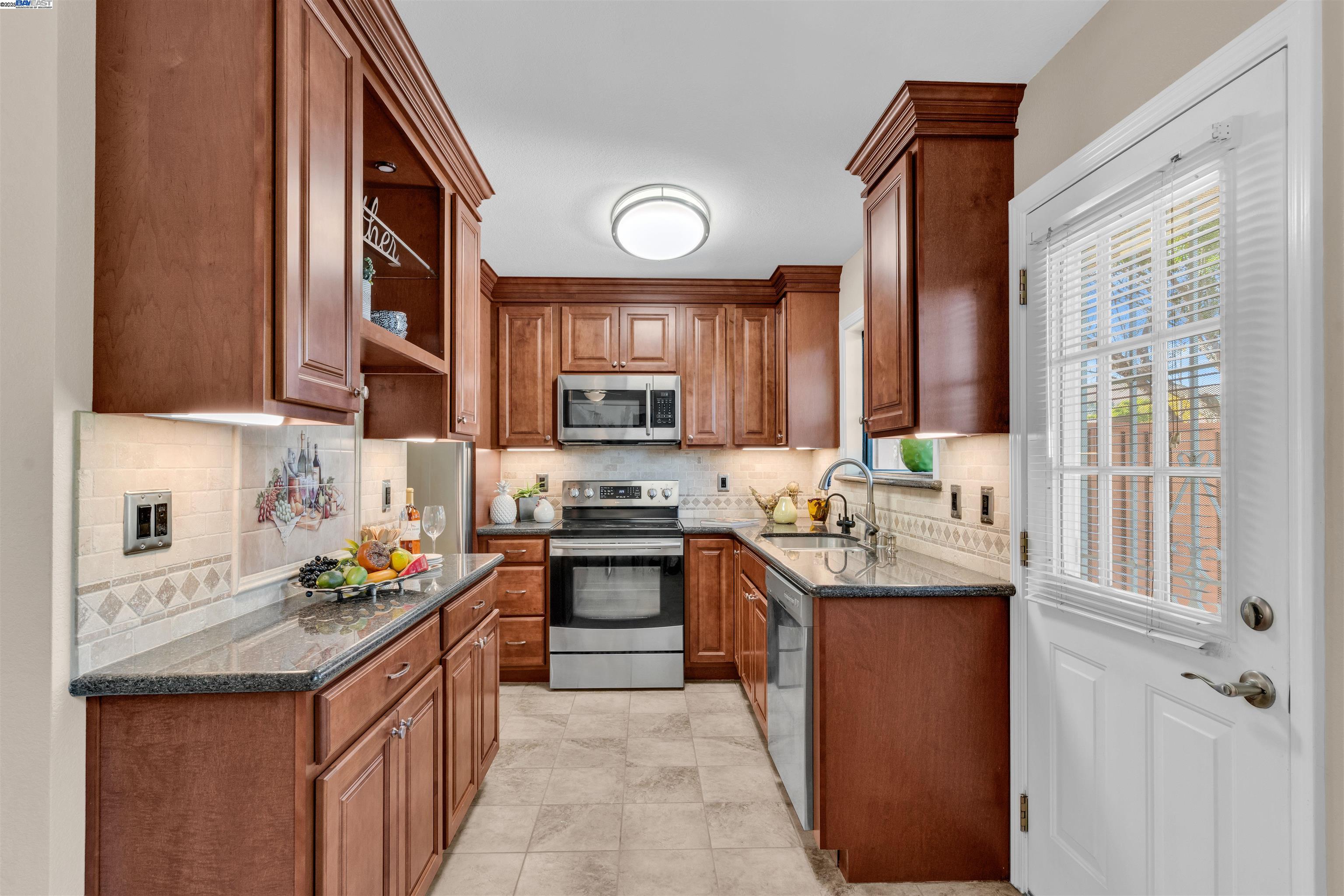 7602 Arbor Creek Circle Dublin, CA 94568 - Photo 15 of 47 a kitchen with stainless steel appliances granite countertop a sink stove and cabinets