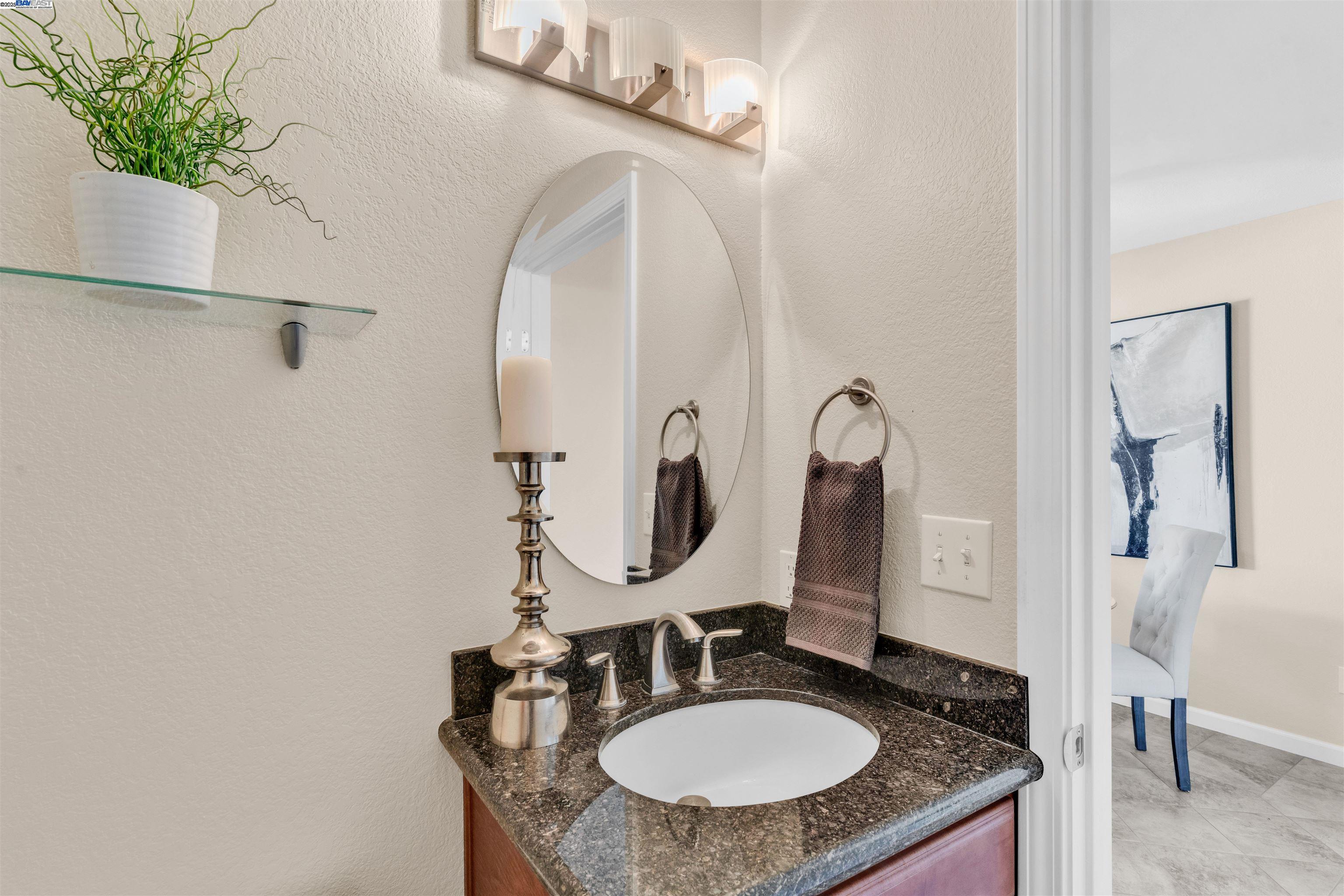 7602 Arbor Creek Circle Dublin, CA 94568 - Photo 22 of 47 a bathroom with a sink and a mirror