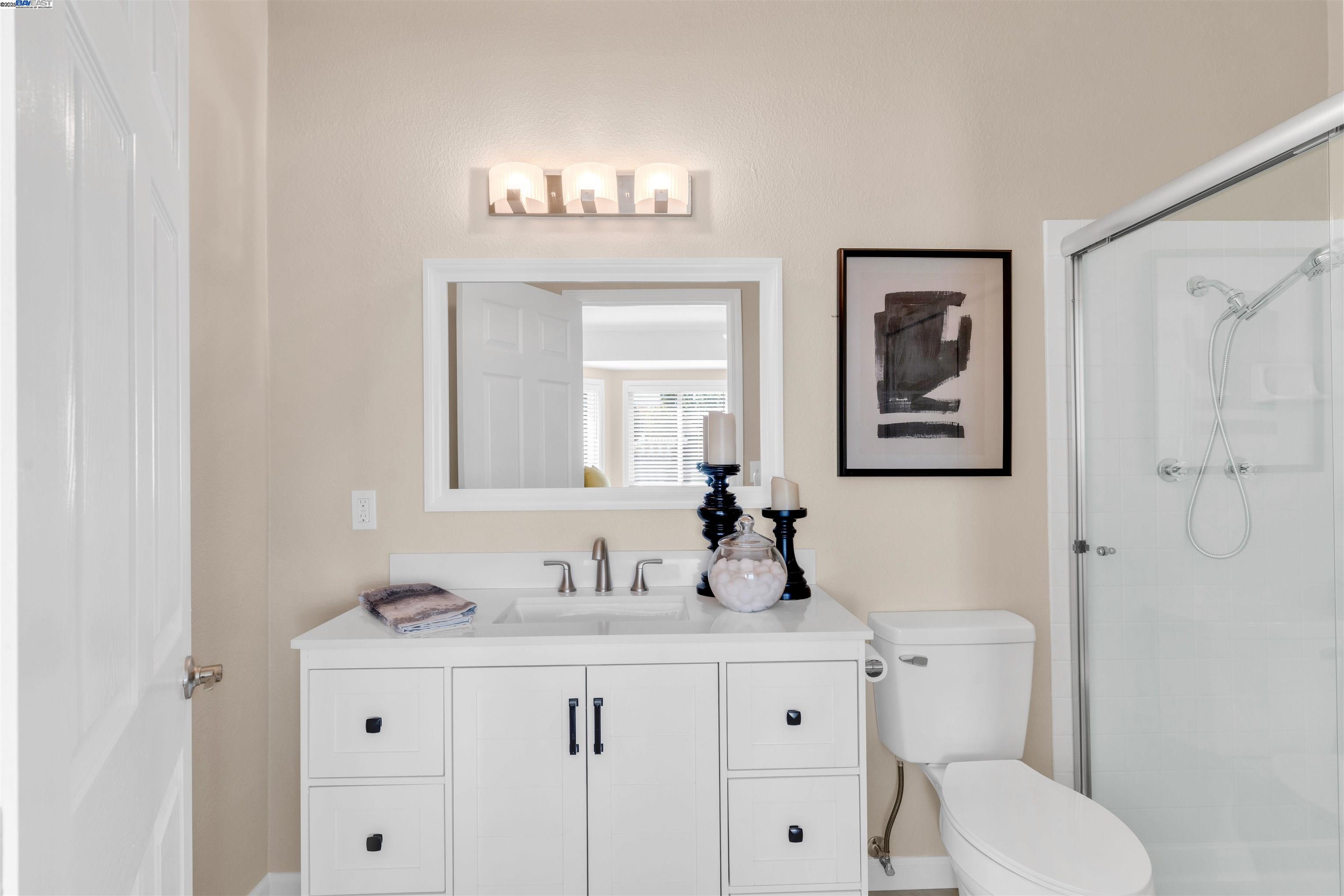 7602 Arbor Creek Circle Dublin, CA 94568 - Photo 27 of 47 a bathroom with a toilet a sink and mirror