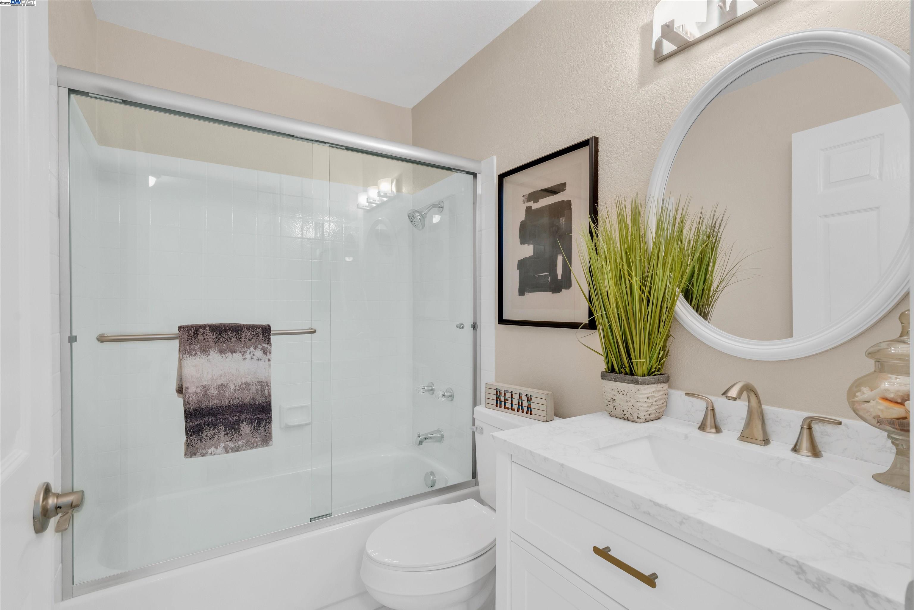 7602 Arbor Creek Circle Dublin, CA 94568 - Photo 32 of 47 a bathroom with a toilet a sink a mirror a shower and vanity