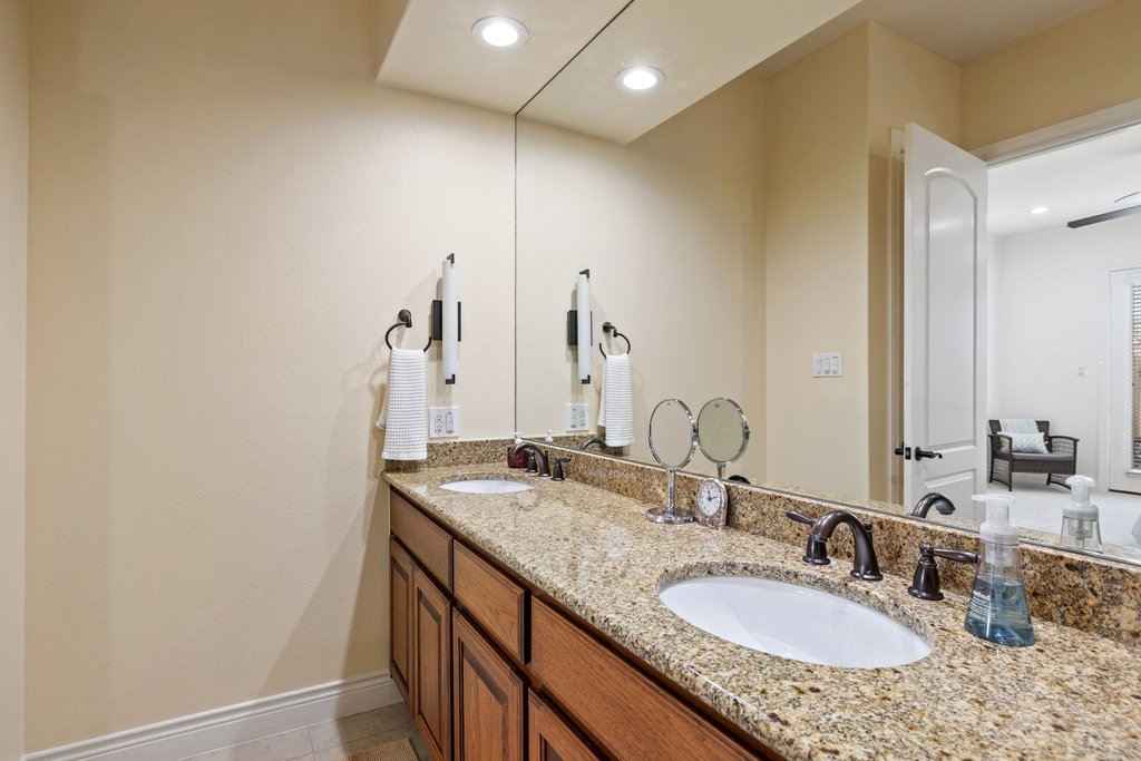 108-2 Rivalto Circle, Unit 2 Lakeway, TX 78734 - Photo 12 of 21 a bathroom with a granite countertop sink and a mirror