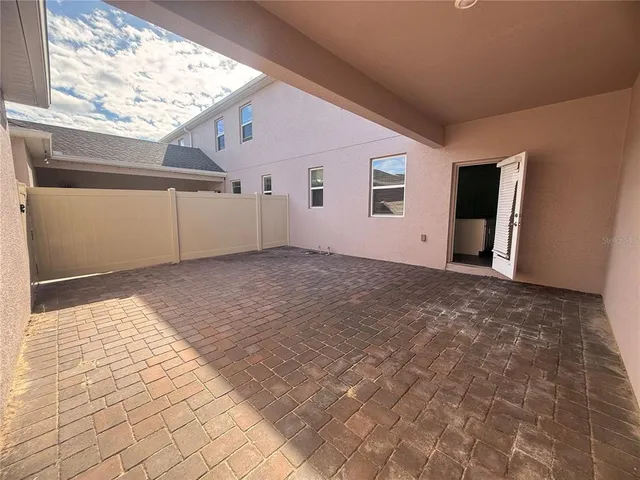 a view of a big room with wooden floor and windows