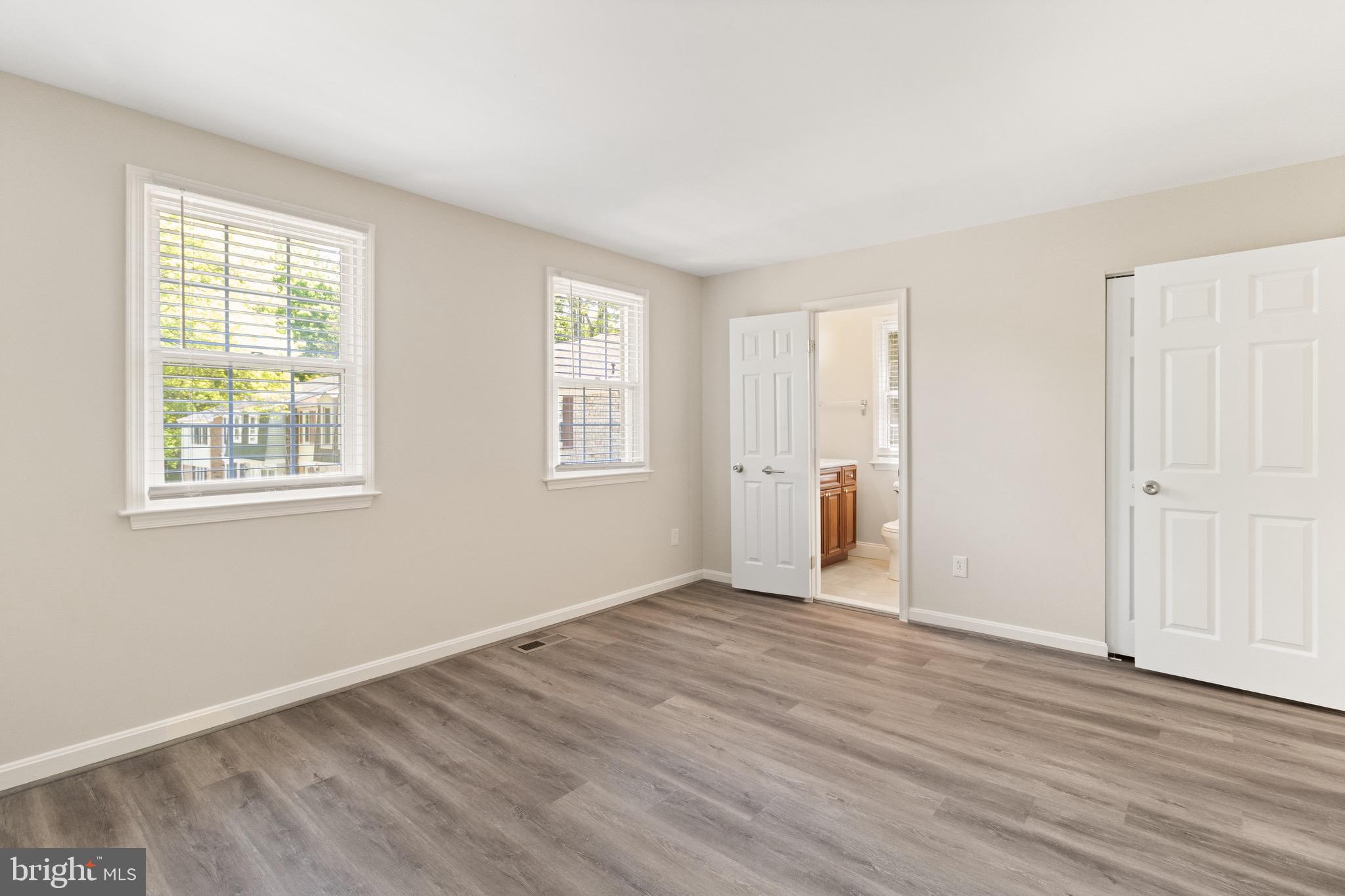 8581 Chester Grove Court Springfield, VA 22153 - Photo 21 of 38 a view of an empty room with wooden floor and a window