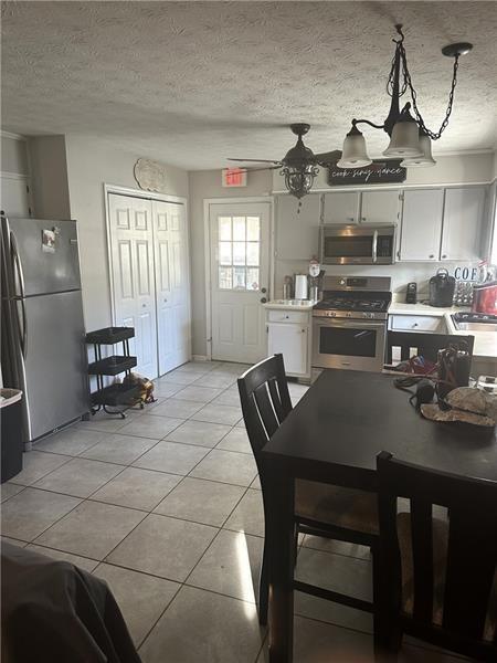 10 Dial Road Monroe, GA 30655 - Photo 4 of 13 a kitchen with stainless steel appliances wooden floor dining table and chairs