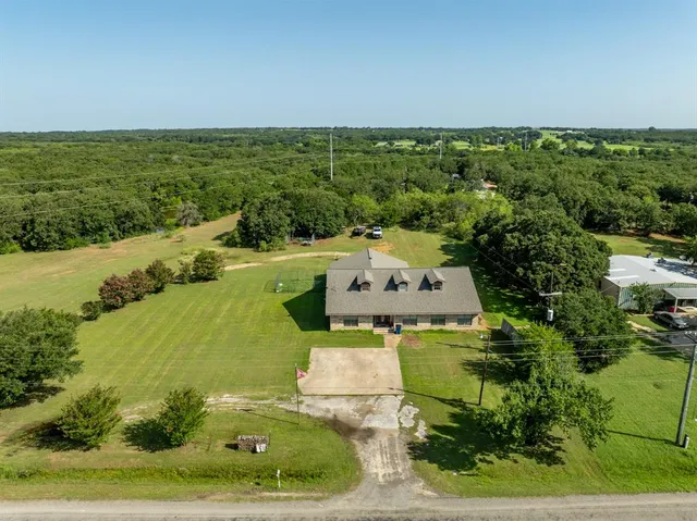 an aerial view of a house with a yard