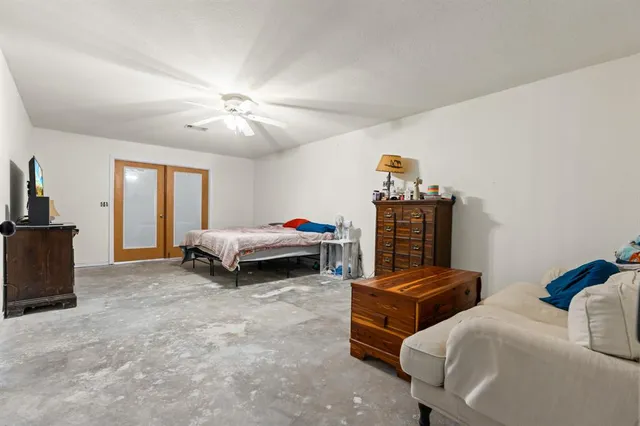 a bedroom with bed and window