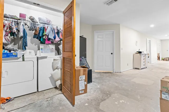 a view of walk in closet with clothes