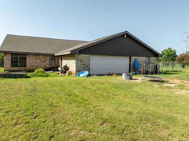 a front view of house with yard and green space