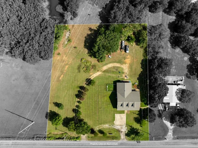 an aerial view of a residential houses with outdoor space