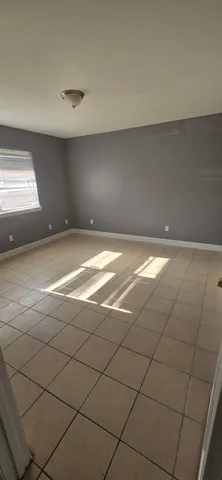 a view of an empty room and a window