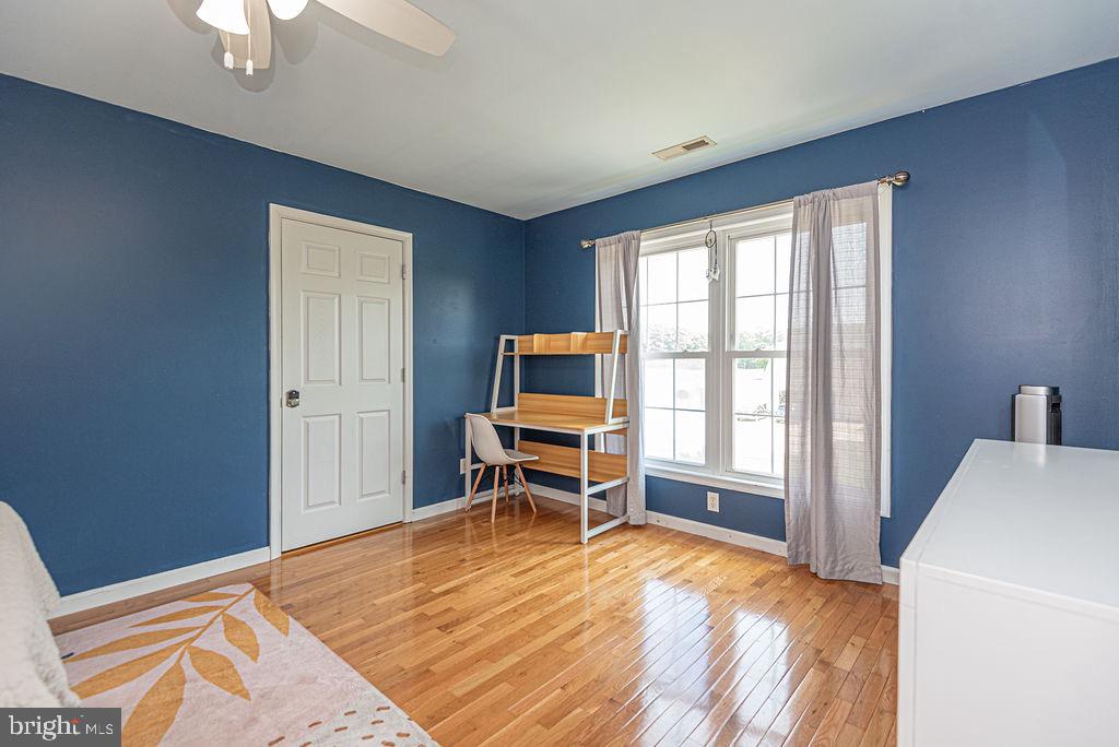 10671 Cathell Road Berlin, MD 21811 - Photo 45 of 63 a bedroom with a bed and a chair