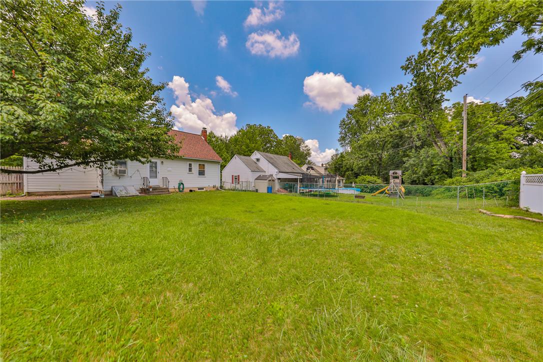 3050 Cornwall Road Bethlehem, PA 18017 - Photo 75 of 80 A generous verdant yard awaits, offering ample space for leisure and outdoor activities, with a glimpse of a refreshing pool.