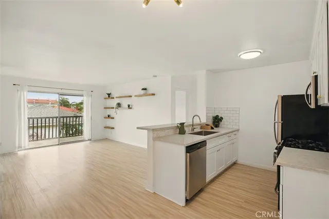 a kitchen with a refrigerator and a stove top oven