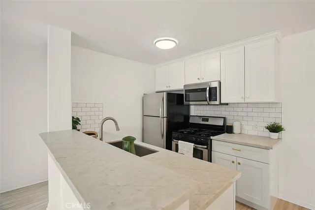 a kitchen with a sink a stove and refrigerator