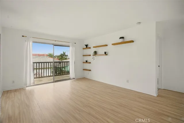 a view of a kitchen with a sink and wooden floor