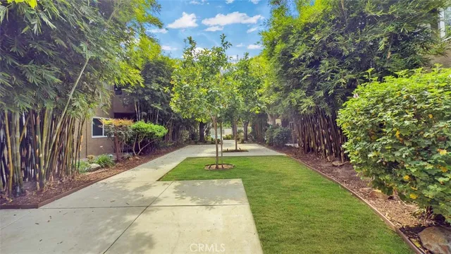 a view of a house with a yard and sitting area