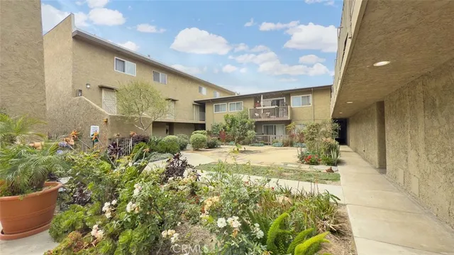 a view of a building with parked cars