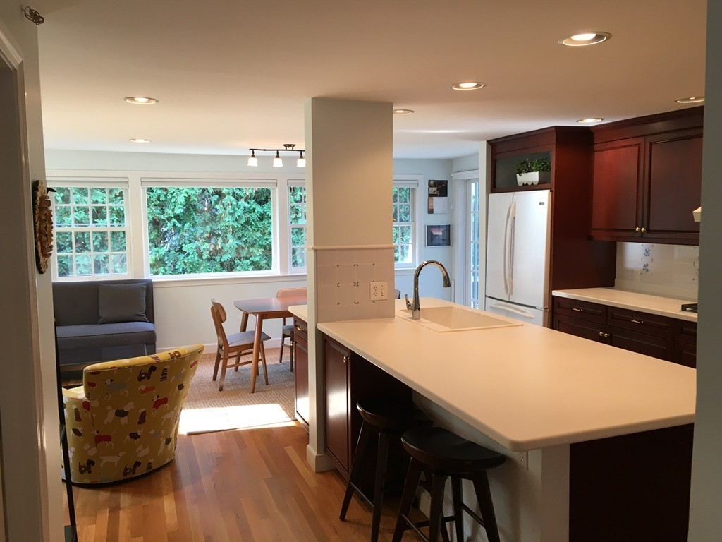 14 Windemere Road Wellesley, MA 02481 - Photo 7 of 25 a large kitchen with kitchen island a dining table and chairs