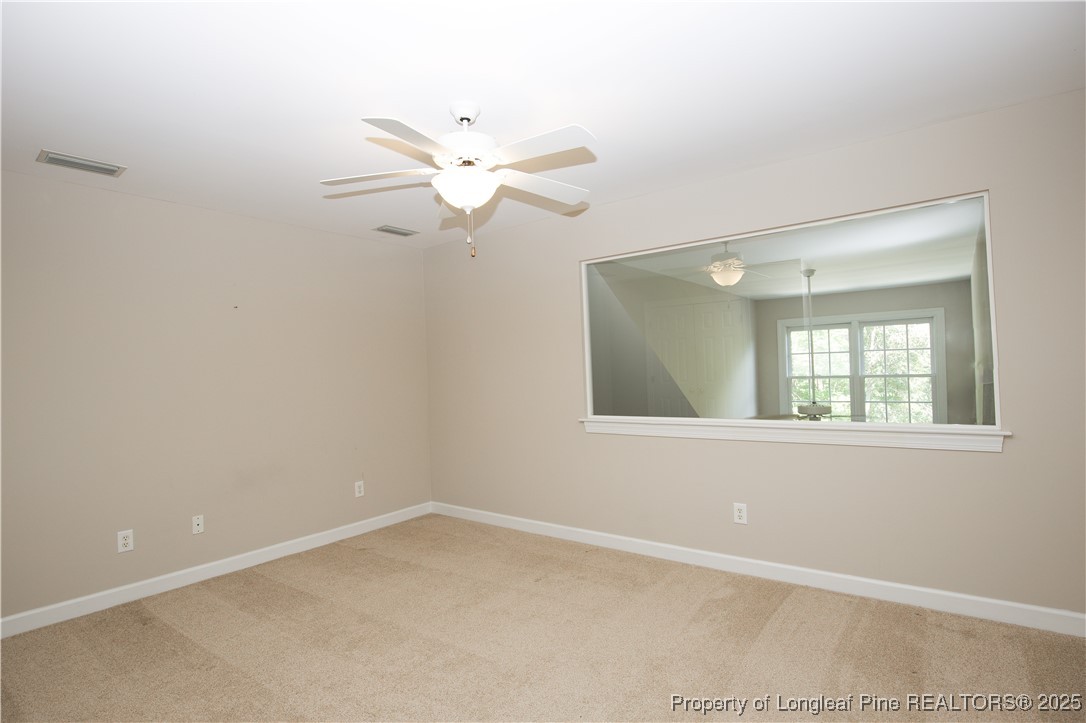 175 Knoll Road Southern Pines, NC 28387 - Photo 34 of 50 an empty room with a window and a fan