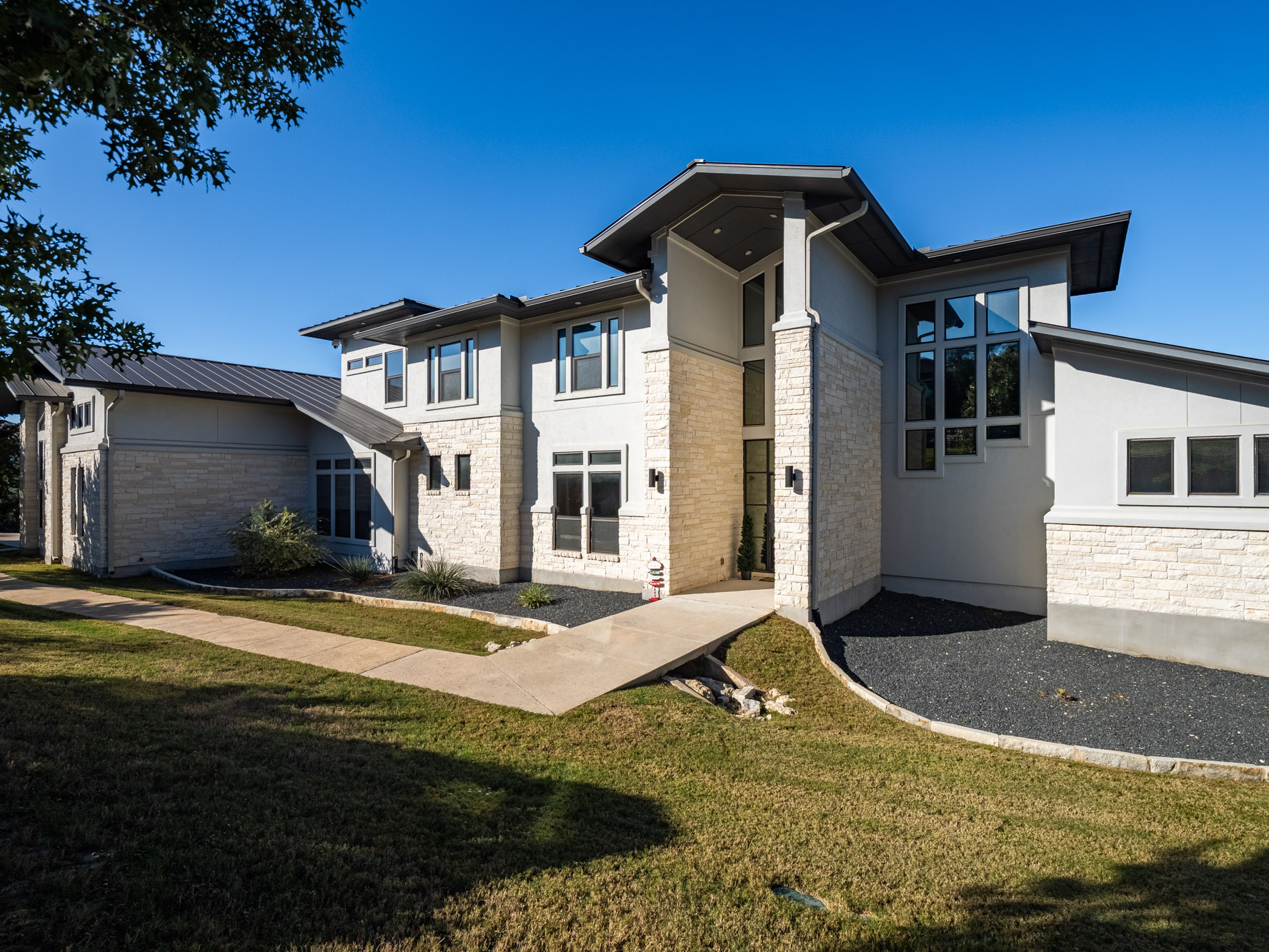 14900 Copper Ridge Lane Austin, TX 78734 - Photo 1 of 39 View of front of home with stone siding, stucco siding, and a front lawn