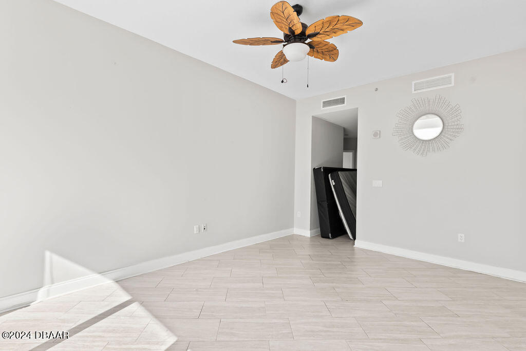 241 Riverside Drive, Unit 2610 Daytona Beach, FL 32117 - Photo 16 of 31 a view of a room with wooden floor and ceiling fan